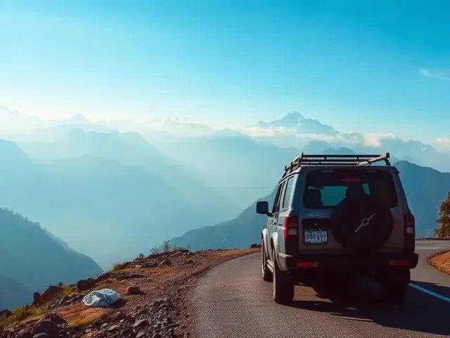 SUV on a mountain road facing misty Himalayan peaks